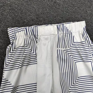 Detail of geometric print pants with elastic waistband and high-contrast blue patterns