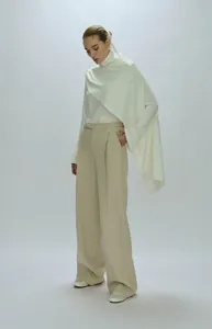 Minimalist two-piece set featuring white turtleneck top with khaki wide-leg trousers
