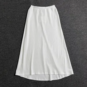 Detailed view of a white A-line cotton skirt featuring a flexible elastic waistband design