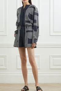Detail of navy blue geometric print fabric on long sleeve shirt and matching shorts