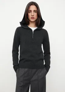 Detailed close-up of dark charcoal half-zip knit hoodie with smooth metal zipper