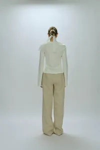 Detail view of the elegant lace hair tie and the back of a minimalist two-piece knit set