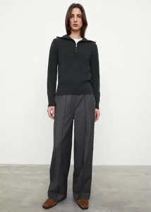 Detail of dark grey half-zip knitted sweater with premium texture and metal zipper