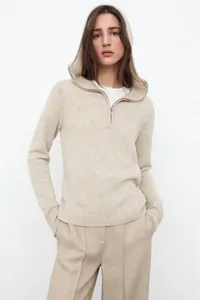 Detail view of the beige half-zip hoodie knit sweater with ribbed cuffs and hemline