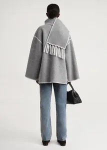 Detail of wool coat back with white stitch edge and matching fringed scarf detail