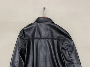 Rear view of black leather shirt showing high-quality texture and horizontal back stitching