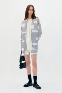 Detail of women's long-sleeve shirt and shorts set with abstract geometric patterns