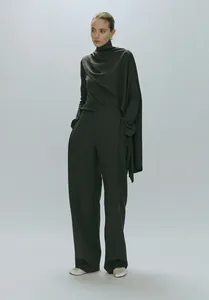 Detail showing high-neck flared sleeve top with asymmetrical drape and wide-leg trousers