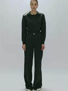 Detail of dark green polo collar knit sweater and high-waist wide-leg trousers set