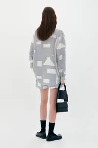 Back view of a loose-fit geometric print long sleeve shirt and matching shorts set for women