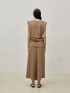 Rear view of a camel-colored sleeveless top with shoulder pads and a long skirt set