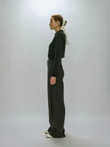 Detail of premium charcoal grey polo knit sweater and wide-leg trousers ensemble