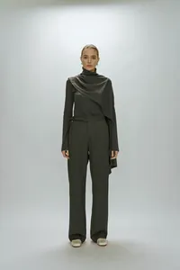 Detail view of the elegant high collar layering and scarf-style drape on a long sleeve top