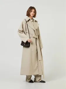 Classic khaki long trench coat with waist belt and crossbody leather bag for women