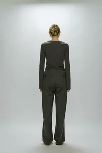 Rear view of dark brown long sleeve top and matching trousers set with elegant drape