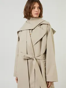 Detailed layered collar and waist belt on a khaki long trench coat for women