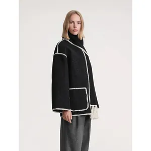 Women's black wool coat with white contrast stitching, tassel hem, and high neck design