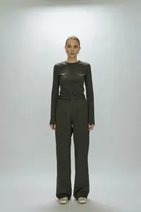 Detail view of taupe long-sleeved top and wide-leg trousers with premium knit texture