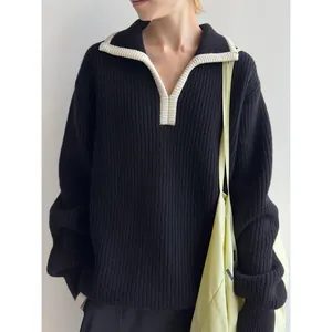 Women's loose black knit sweater with contrast polo collar and ribbed texture