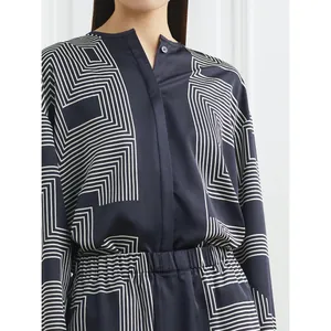 Women's dark blue satin blouse with white geometric patterns and stand collar design