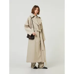 Minimalist long khaki trench coat with detachable hood and waist belt for women