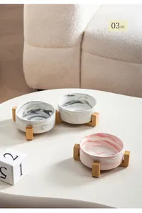 Detail of marble pattern ceramic pet bowl with wooden stand fired at 1260 degrees