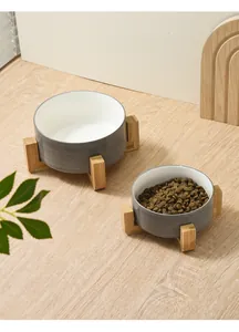 Detail view of two grey stone texture ceramic pet bowls with bamboo stand and dry food