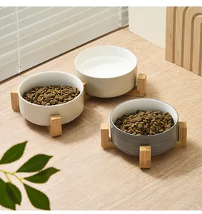 Three ceramic pet bowls set with wooden cross-stand for dry food and water