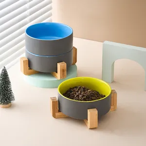 Elevated ceramic pet bowl set with wooden stand and matte grey exterior finish