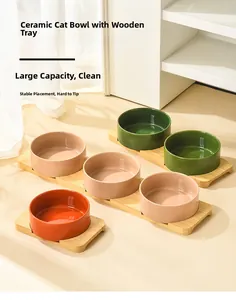 Close-up of ceramic cat bowls with natural bamboo trays in three elegant colors