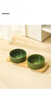 Detail of high-temperature ceramic green cat bowls with anti-slip bamboo stand base