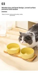 Double yellow ceramic cat bowls with bamboo stand featuring a long-haired cat eating