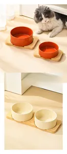 Detail showing smooth ceramic bowls in wooden stands for cats and small dogs