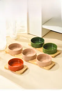Detail of colorful ceramic pet bowls with a sturdy bamboo wooden stand base