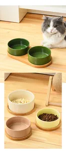 Macro detail of ceramic pet bowls with wooden stand and wide circular opening design