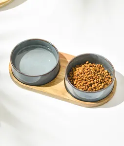 Dual ceramic pet bowls set with wooden stand featuring dry food and water detail