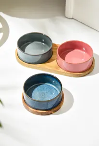 Macro detail of high-quality ceramic pet bowls on a sturdy wooden base in a minimalist home