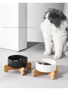Minimalist black and white ceramic cat bowls with cross bone-shaped bamboo wood stand