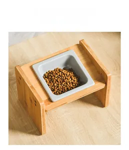 Macro view of tilted bamboo stand with a square ceramic bowl for pet feeding comfort