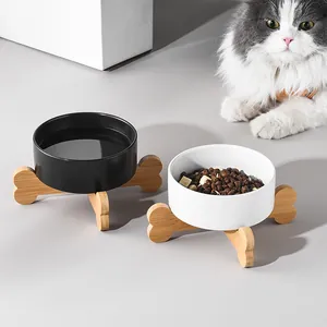 Set of black and white ceramic cat bowls with elevated bamboo bone-shaped stands