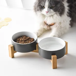 Modern elevated pet feeder with two ceramic bowls on a minimalist bamboo stand