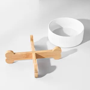 Minimalist white ceramic cat bowl with a bone-shaped bamboo wooden elevated stand