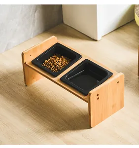 Elevated bamboo pet feeder with dual square black ceramic bowls for cats and small dogs