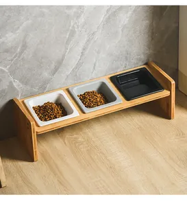 Close-up of triple bamboo raised pet stand with white, gray and black ceramic square cat bowls