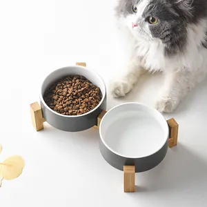 Detail view of elevated double ceramic pet bowls with a wooden stand for cats and small dogs