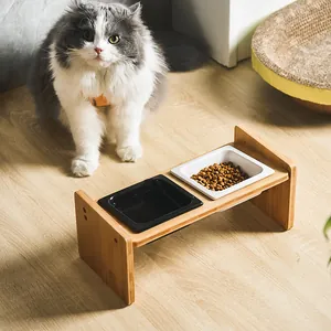 Elevated wooden pet feeder with black and white ceramic bowls for cats and small dogs