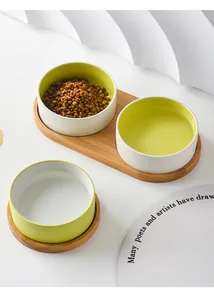 Dual ceramic pet bowls on wooden stand with kibble and water for small dogs