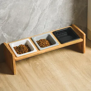 Elevated wooden pet feeding stand with three colorful square ceramic bowls for cats and dogs