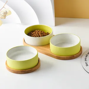 Ceramic pet bowl set with bamboo stand for food and water in minimalist two-tone design