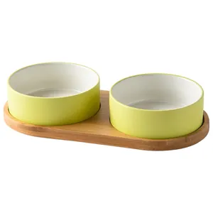 Ceramic double cat bowl set with yellow-green glaze and stable natural wooden tray base